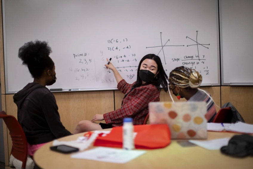 Penn student teaching math to high school students