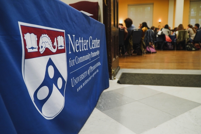 Entrance to ABCS Summit 2019, showing Netter banner and the inside of the room filled with people sitting at tables