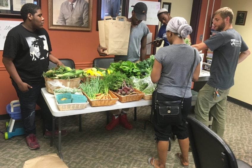 AUNI CSA Nutrition Educator Eric Sherman and students prepare for Good Food Bag pick-ups.